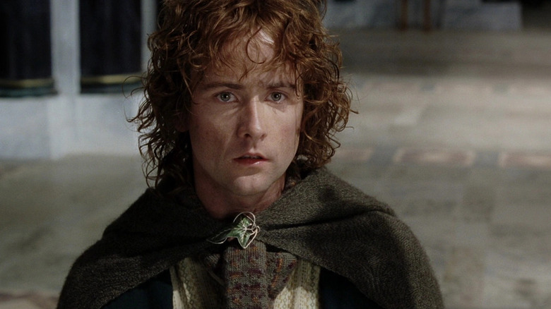Pippin Took (Billy Boyd) stands expectantly in the court of Minas Tirith in The Lord of the Rings: The Return of the King