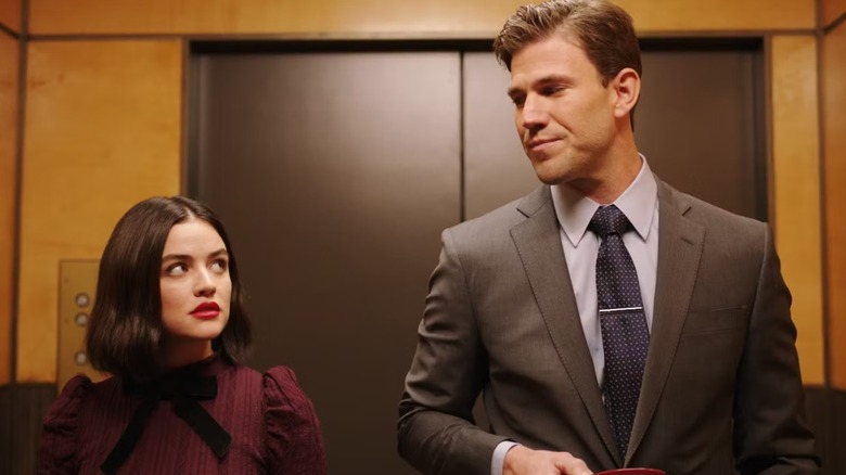 Lucy and Joshua exchange glances during the elevator scene in The Hating Game