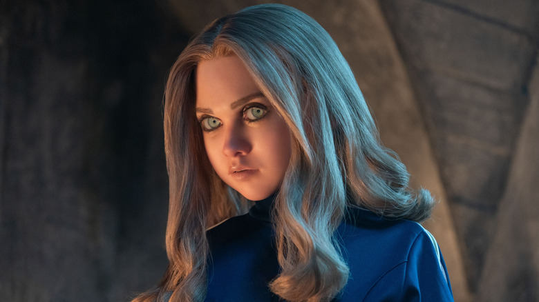 Megan looks to her left in her blue jacket in M3GAN 2.0