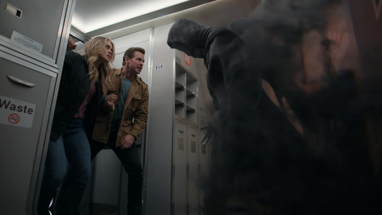 Josh Dallas and Melissa Roxburgh as Ben and Michaela fighting a ghostly spirit on Manifest