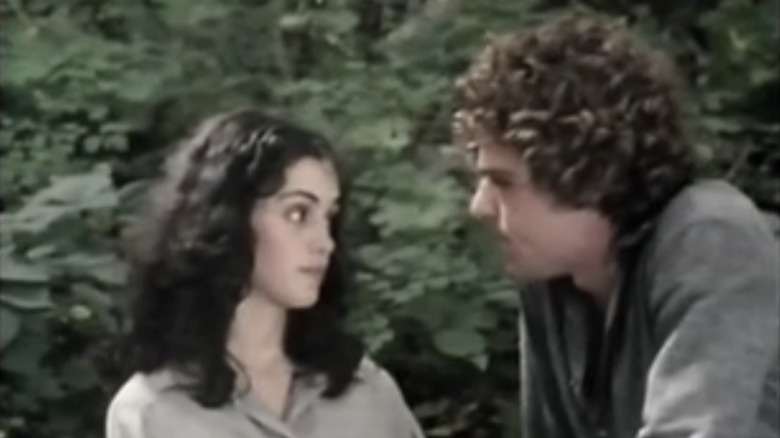 Kathleen Beller's Kate sits alongside Joseph Bottoms' Joe in the woods in Surfacing