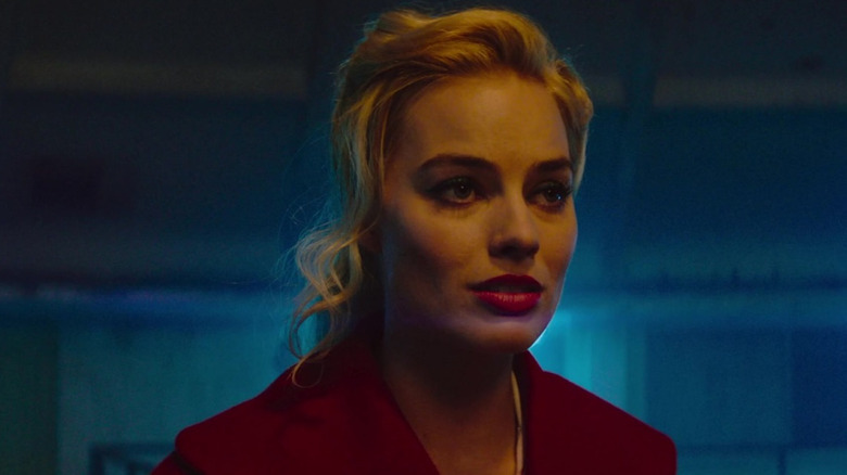 Margot Robbie in a red jacket in close-up in Terminal