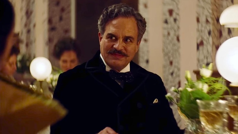 Duncan Wedderburn (Mark Ruffalo) sits in a fancy restaurant in Poor Things