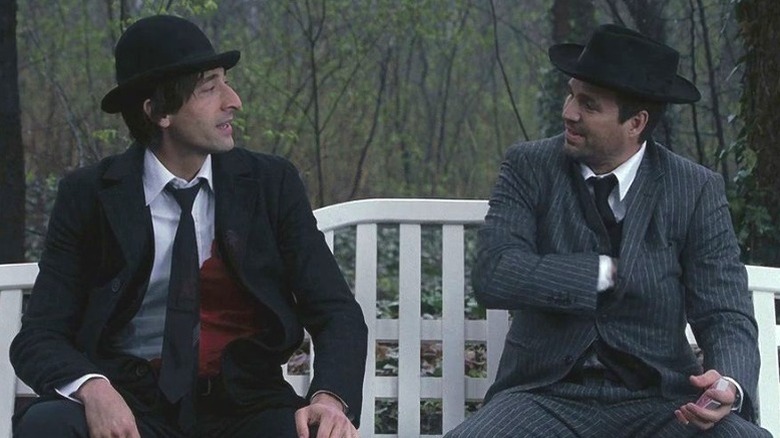 Bloom (Adrien Brody) and Stephen (Mark Ruffalo) sit on a bench together in The Brothers Bloom