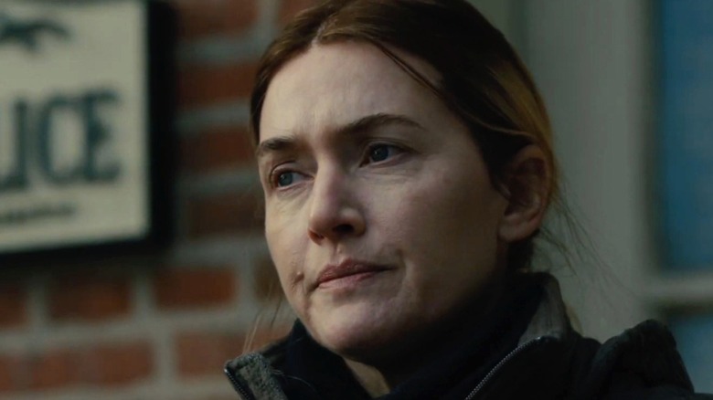 Kate Winslet as Mare looking somber in Mare Of Easttown