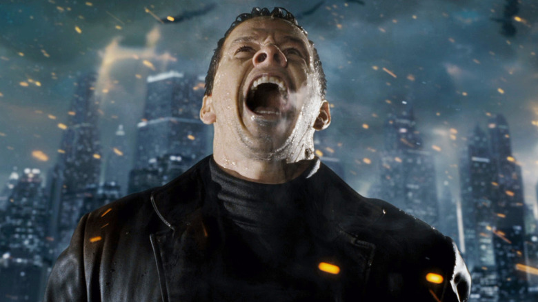 Mark Wahlberg's Max Payne screams as he stands in a firery hellscape in Max Payne