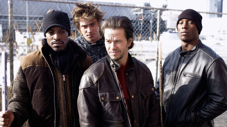 Bobby, Jerry, Angel, and Jack standing together by a fence in Four Brothers