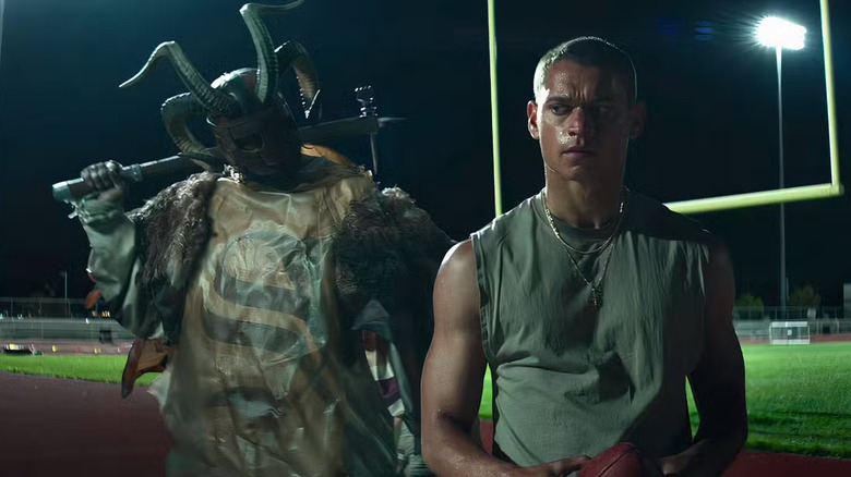 Cam about to be hit in the head with a hammer by a bizarre goat being in Him