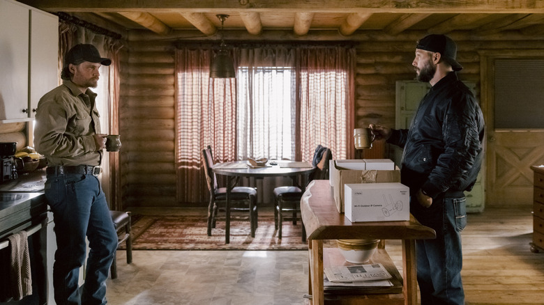 Luke Grimes' Kayce Dutton stands opposite Logan Marshall-Green's Pete Calvin in Kayce's cabin in Marshals