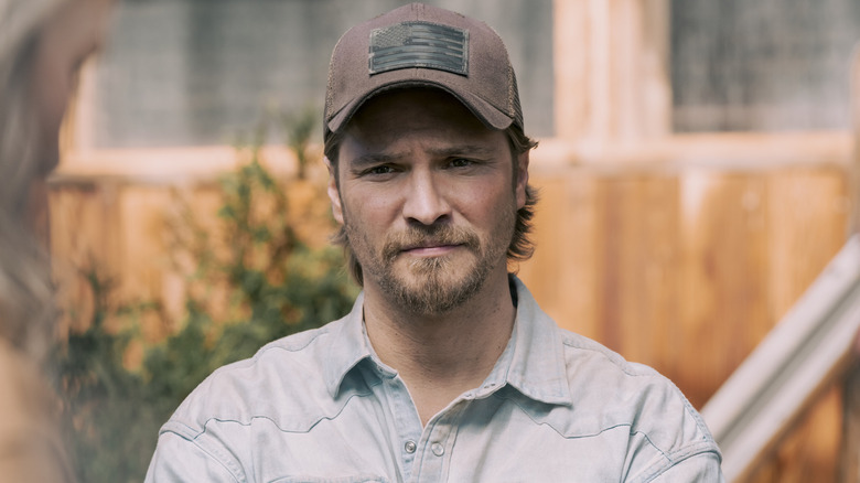 Luke Grimes' Kayce Dutton is seen in closeup as he stands outside in Marshals