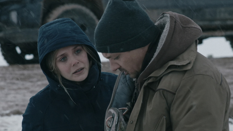Elizabeth Olsen's Jane Banner stands next to Jeremy Renner's Cory Lambert outside in a snowy environment in Wind River