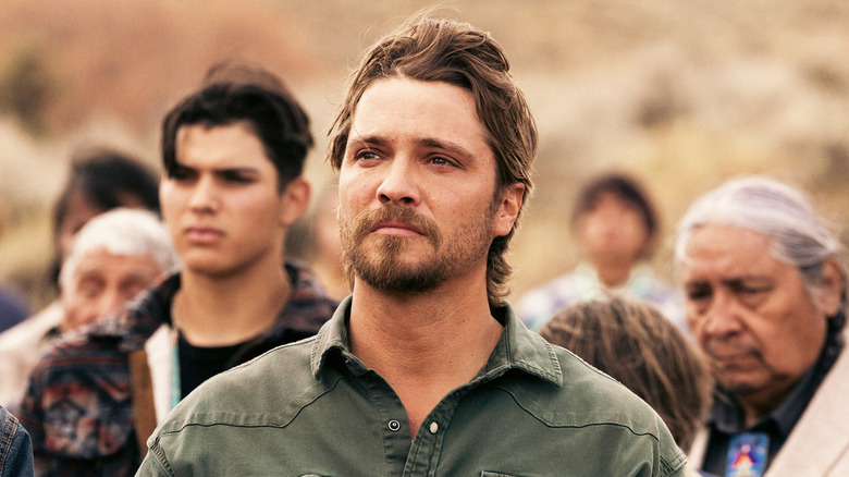 Luke Grimes' Kayce Dutton holds his hat to his chest at a remembrance ceremony in Marshals