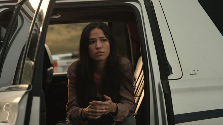 Kelsey Asbille's Monica Dutton sits in the back seat of a truck looking worried in Yellowstone