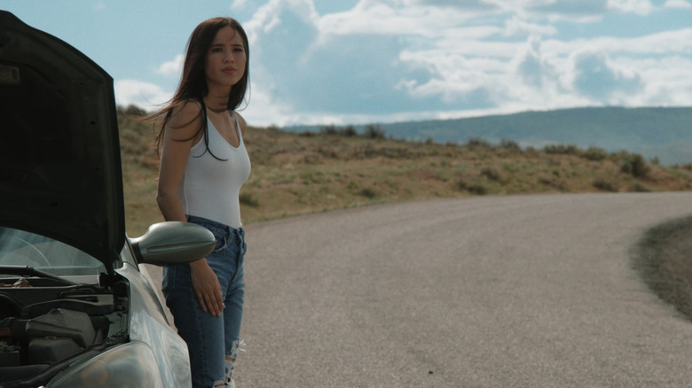 Kelsey Asbille's Monica Dutton stands by a truck on the side of the road in Yellowstone