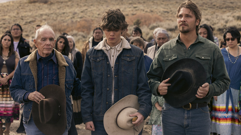 Felix (Rudy Ramos), Tate (Brecken Merrill), and Kayce (Luke Grimes) standing together with their hats removed on Marshals