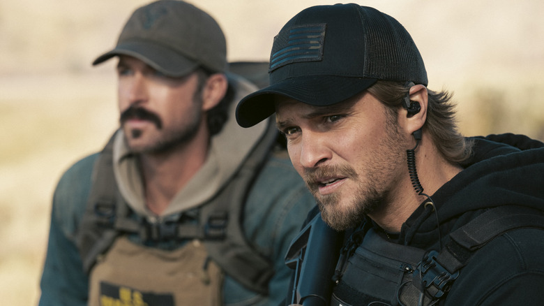 Garrett (Riley Green) and Kayce Dutton (Luke Grimes) observing something on 