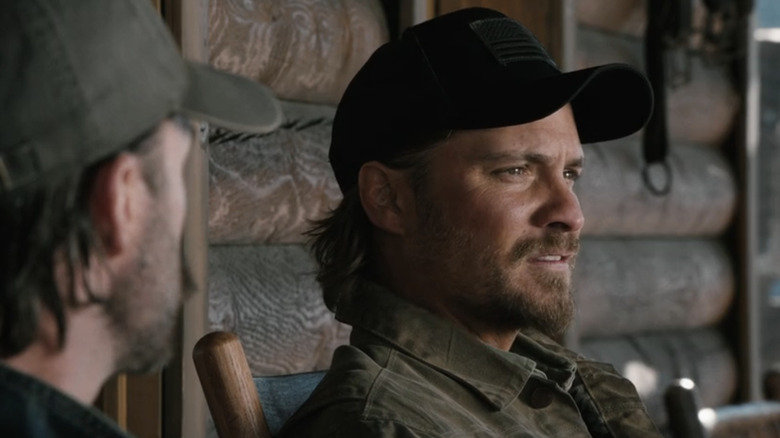 Luke Grimes' Kayce Dutton looks off into the distance as he sits on his porch in Marshals