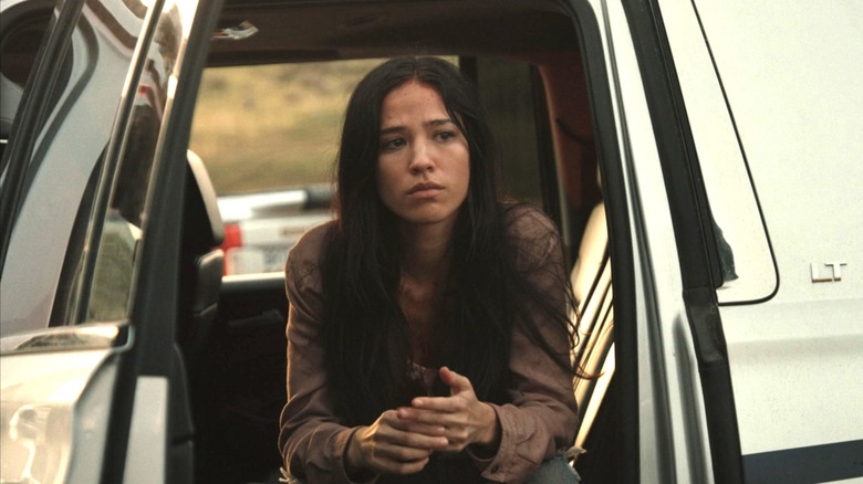 Kelsey Asbille's Monica Dutton looks shaken as she sits in a truck in Yellowstone