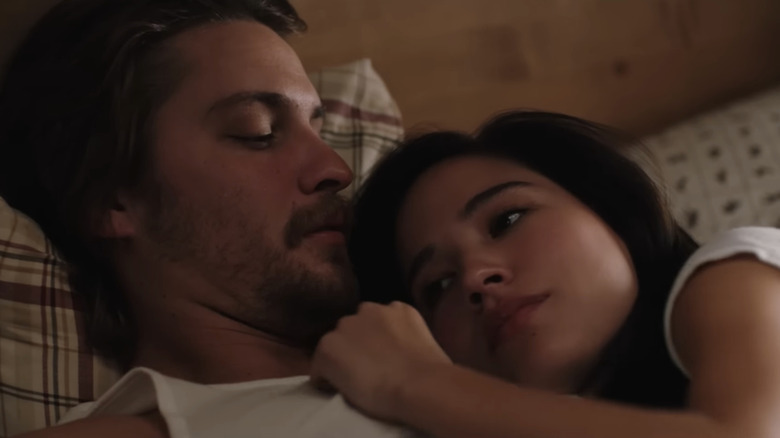 Kelsey Asbille's Monica Dutton lays on the chest of Luke Grimes' Kayce Dutton in bed in Yellowstone