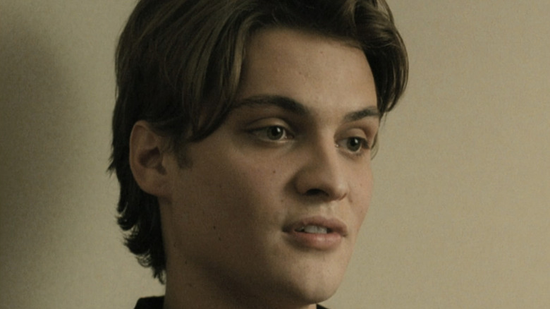 Luke Grimes' Marlon Piazza is seen in closeup against a white wall in Assassination of a High School President