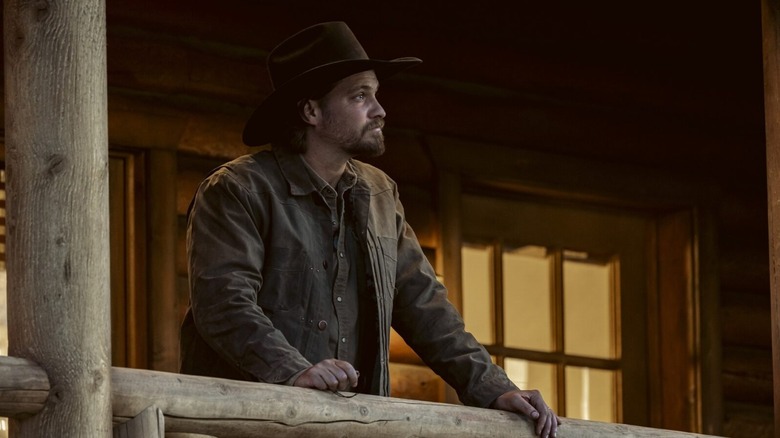 Luke Grimes' Kayce Dutton looks at someone standing off-screen as he stands outside in Marshals