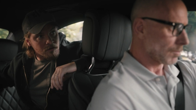 Matt Gerald's Grant Horton sits in a car with Luke Grimes' Kayce Dutton in the back seat in Yellowstone