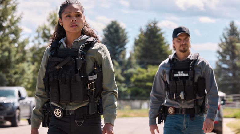 Ash Santos' Andrea Cruz and Luke Grimes Kayce Dutton stand side by side in their tactical gear in Marshals