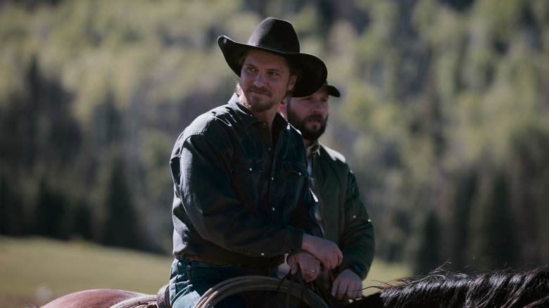 Luke Grimes' Kayce Dutton rides on a horse beside Logan Marshall-Green's Pete Calvin in Marshals