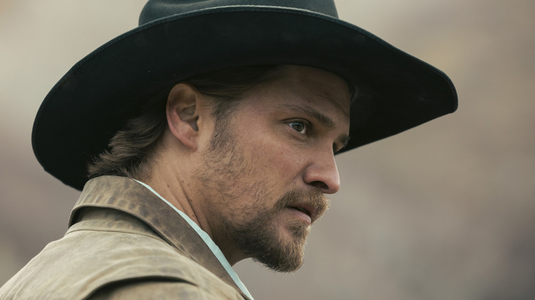 Luke Grimes' Kayce Dutton is seen in closeup profile as he stands outside in Marshals