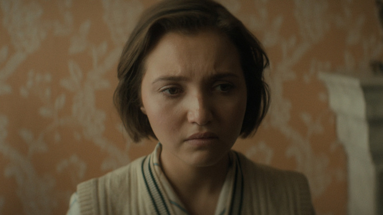 Mia McKenna-Bruce's Lady Bundle Brentin is seen in closeup looking worried in Agatha Christie's Seven Dials