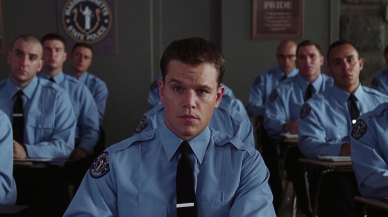 Colin Sullivan in a cop uniform in a classroom in The Departed