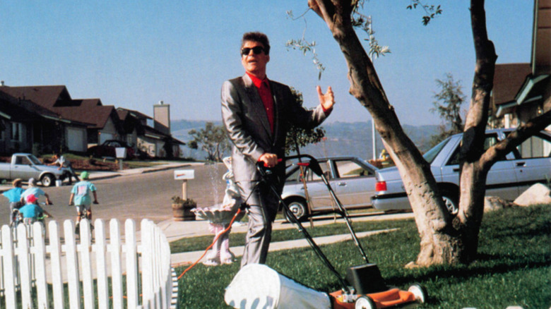 Vinnie Antonelli mowing the lawn in silk suit
