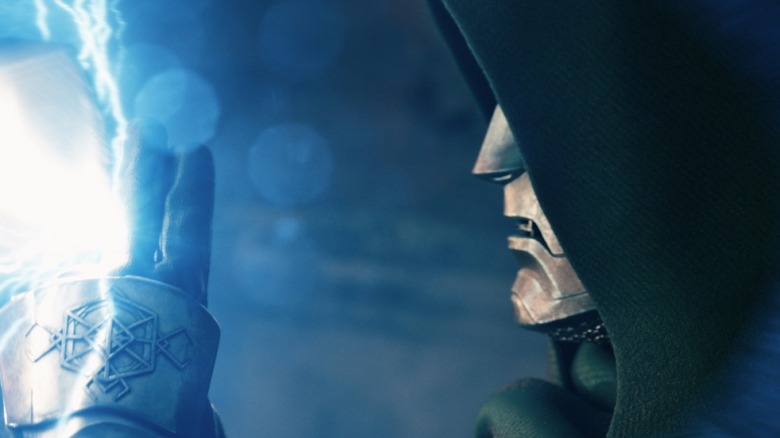 Robert Downey, Jr. as Doctor Doom wearing a mask and hood and deflecting an energy blast with his hand in Avengers: Doomsday