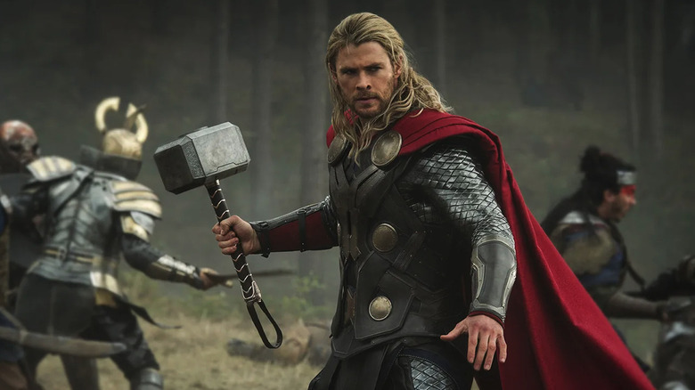Thor (Chris Hemsworth) stands with Mjolnir ready in battle in Thor: The Dark World