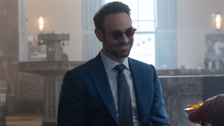Charlie Cox as Matt Murdock grinning in a court room in Daredevil: Born Again season 1