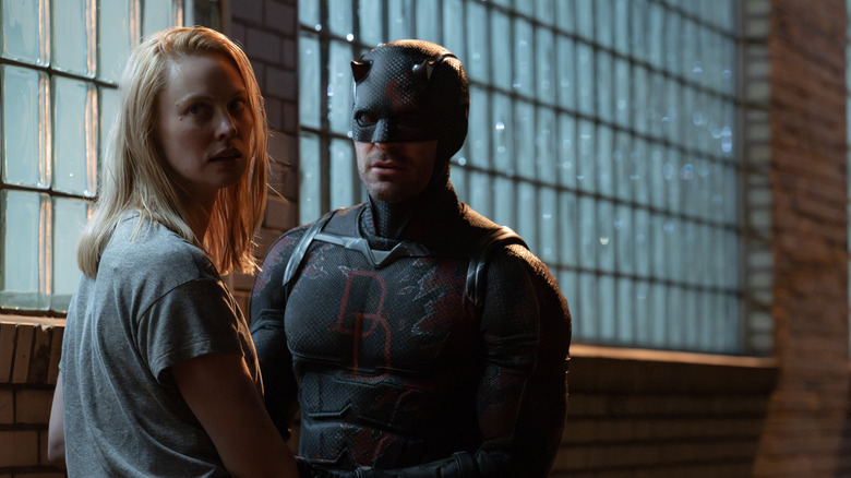 Deborah Ann Woll as Karen Page standing with Matt Murdock as Daredevil in Daredevil: Born Again