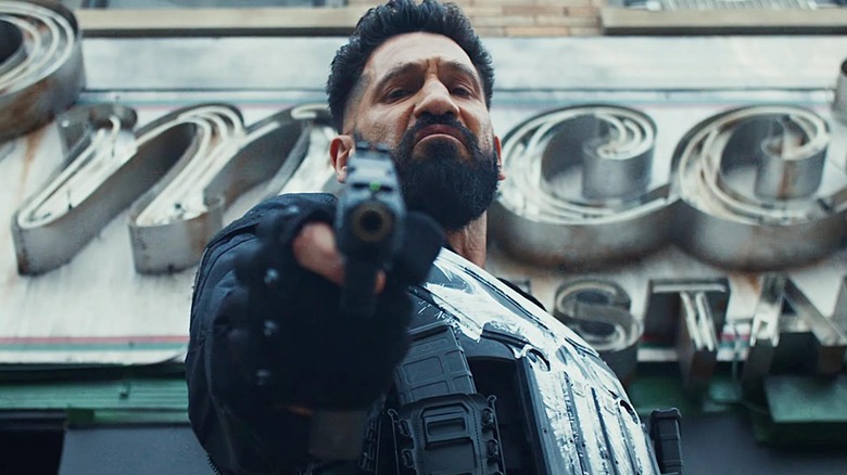 Jon Bernthal as Frank Castle brandishing a gun and looking down in The Punisher: One Last Kill