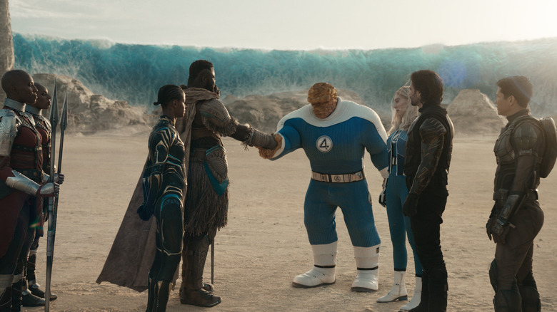 Winston Duke as M'Baku shaking hands with Ebon Moss-Bachrach as Ben Grimm surrounded by several other characters in Avengers: Doomsday