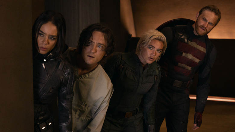 Ghost, Bob, Yelena, and John Walker peer out from behind a wall in Thunderbolts