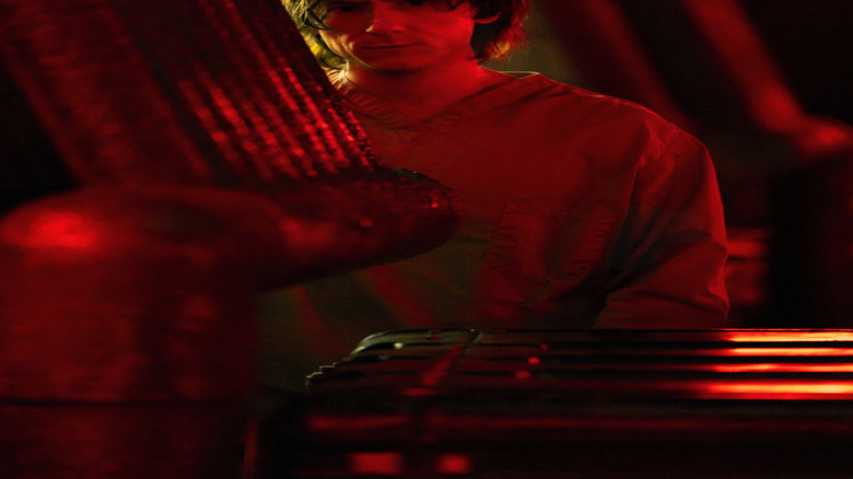 Bob Reynolds partially concealed in red lighting in love at first sight