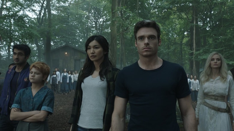 Kingo, Sprite, Sersi, Ikaris, and Thena standing together in a village in Eternals