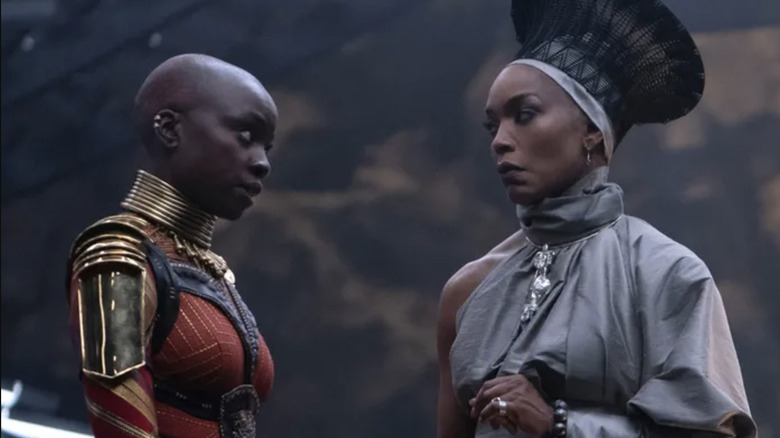 A Dora Milaje talks to Queen Ramonda in Black Panther: Wakanda Forever