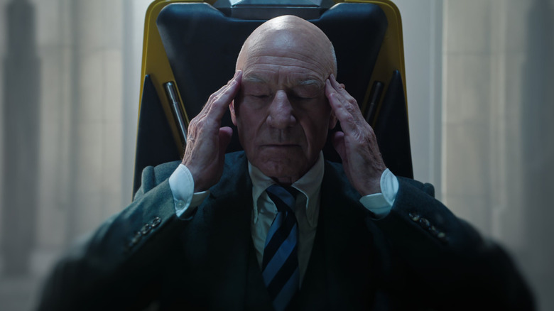 Patrick Stewart as Charles Xavier sitting in his wheelchair with his eyes closed and his fingers on his temples in Doctor Strange in the Multiverse of Madness