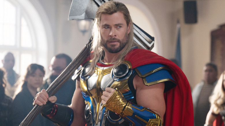 Chris Hemsworth flexing in Thor: Love and Thunder