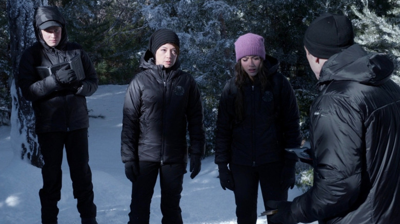 The cast of Agents of S.H.I.E.L.D. looking down while standing in the snow