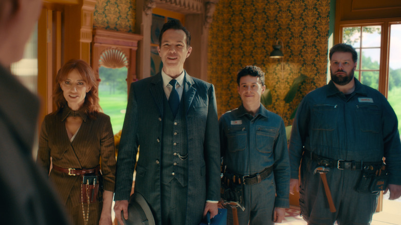 Paul Bettany as Vision standing in front of Orla Brady as Friday, James D'Arcy as Jarvis, Johnathan Sayer as U, and Henry Lewis as DUM-E in their human avatars in VisionQuest