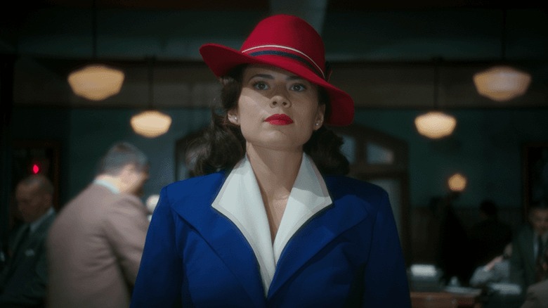 Hayley Atwell as Peggy Carter in her red hat and blue suit in Agent Carter