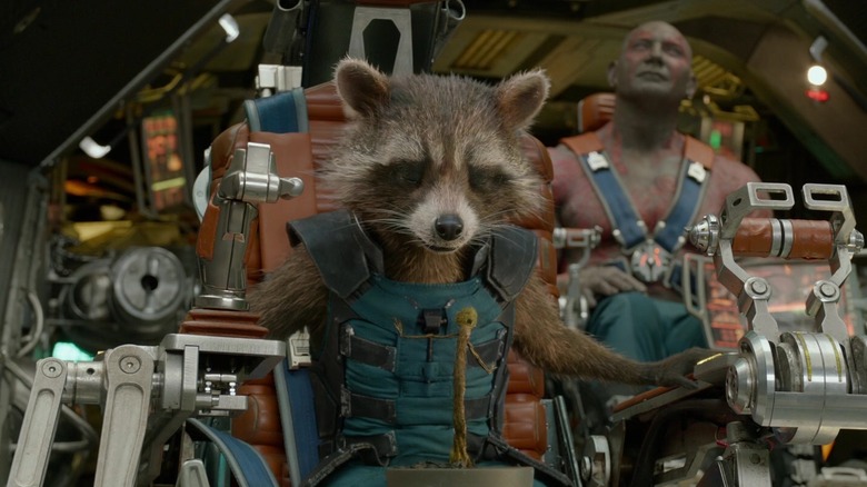 Rocket Raccoon sits at the controls of a ship in Guardians of the Galaxy