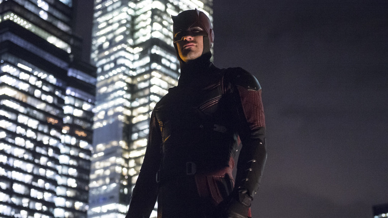 Charlie Cox as a Daredevil standing on a rooftop in Daredevil