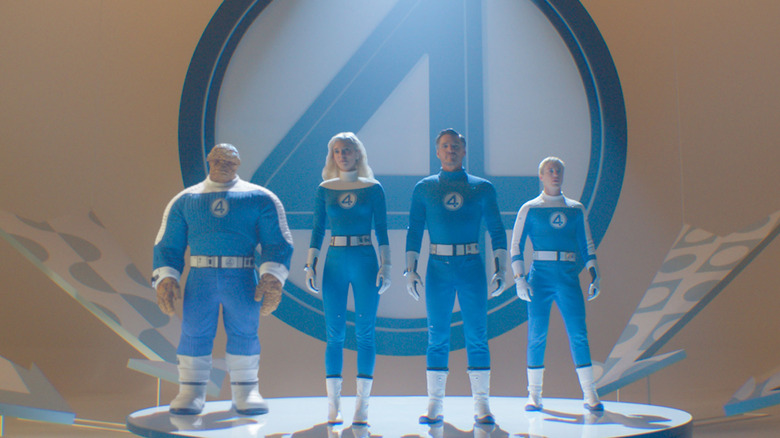 Fantastic Four stands behind a giant sign with their logo in Fantastic Four: First Steps